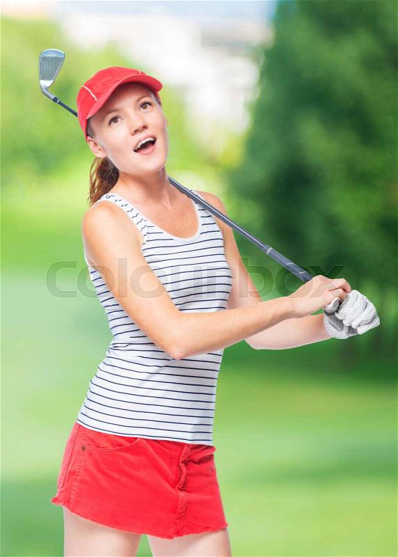 Golfer in cap with golf club on a background of golf courses, stock photo