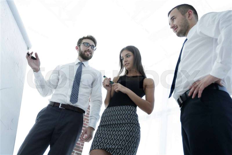 Business man showing something on a whiteboard to his colleagues.business training, stock photo