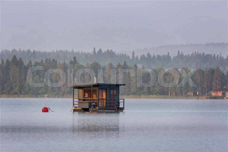Floating sauna on the morning lake, Finland, stock photo