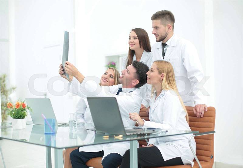 Group of doctors discussing an x-ray ,sitting at the table.the concept of health, stock photo