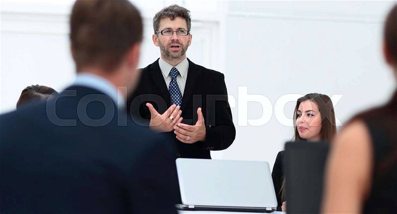Closeup of a senior Manager makes a report at the briefing, stock photo