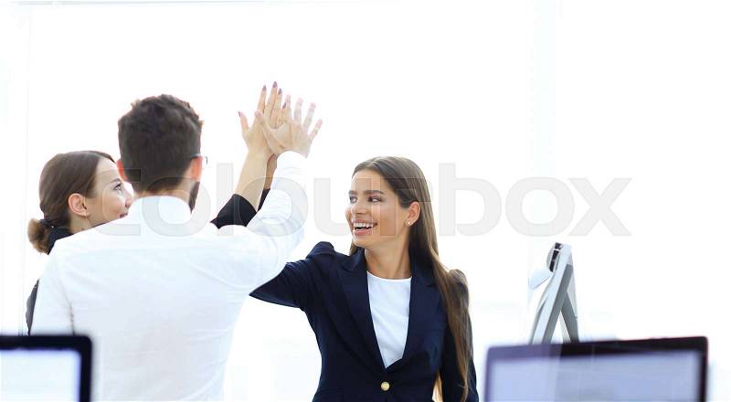 Closeup.business team, giving each other a high five.the concept of teamwork, stock photo