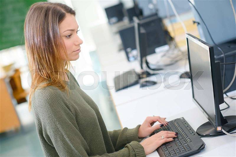 Young woman attending computer class, stock photo