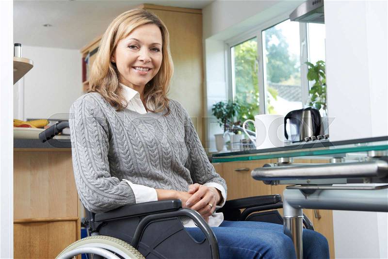 Portrait Of Mature Disabled Woman In Wheelchair At Home, stock photo