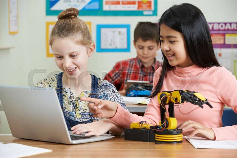 Female Pupils In Science Lesson Studying Robotics, stock photo