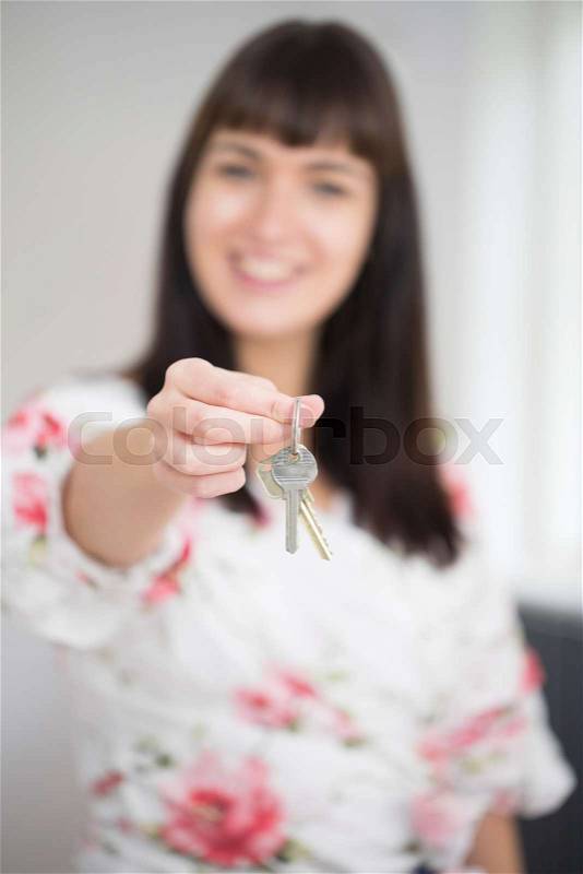Woman Moving Into New Home Holding Bunch Of Keys, stock photo