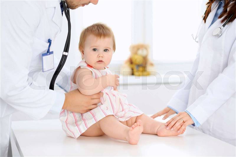 Doctor and patient. Happy cute baby at health exam. Medicine and health care concept, stock photo