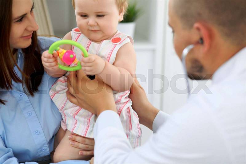 Doctor and patient. Happy cute baby at health exam. Medicine and health care concept, stock photo