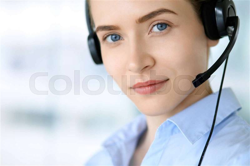 Call center operator. Portrait of beautiful business woman in headset, stock photo