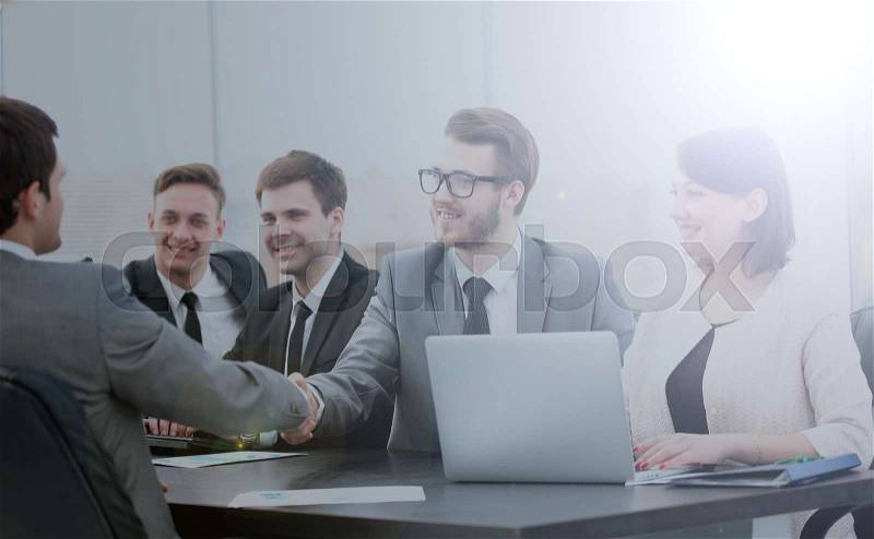 Close-up :Board members,assistant with laptop and commercial Director with a handshake welcomes a new employee. the photo has a space for your text, stock photo