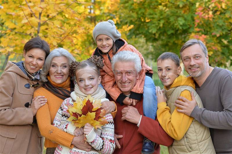 Big happy family having fun in autumnal park, stock photo
