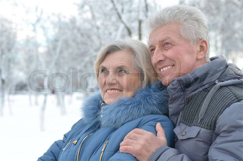 Portrait of happy senior couple at winter outdoors, stock photo