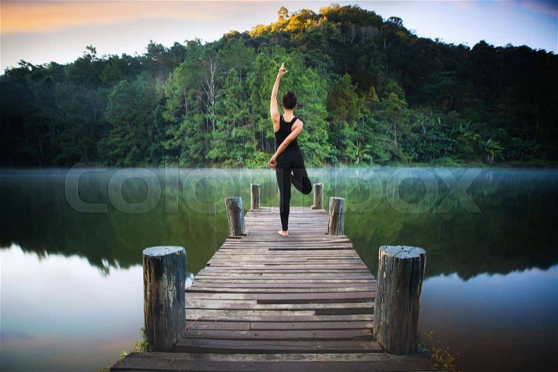 Yoga post on the wooded bridge in Pang ung park, Pangung, Mae Hong Son, Thailand, Asia, stock photo