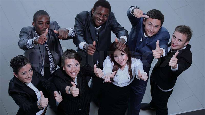 Elevated view of large group of multiethnic business people cheering and showing thumbs up, stock photo