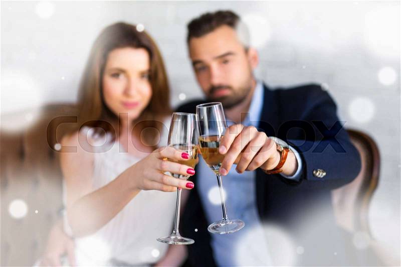 New year celebration - happy beautiful couple with glasses of champagne at restaurant, stock photo