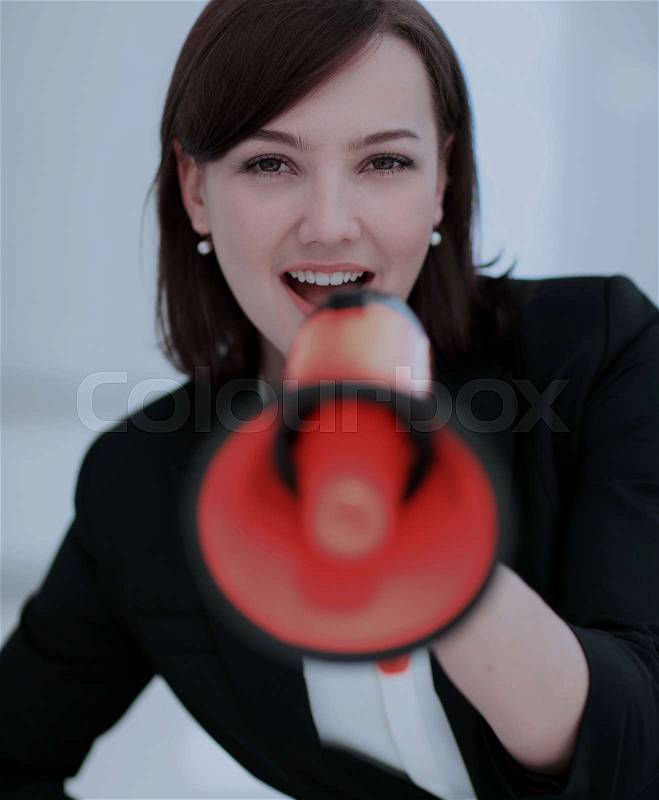 Beautiful business woman using a megaphone to scream, stock photo