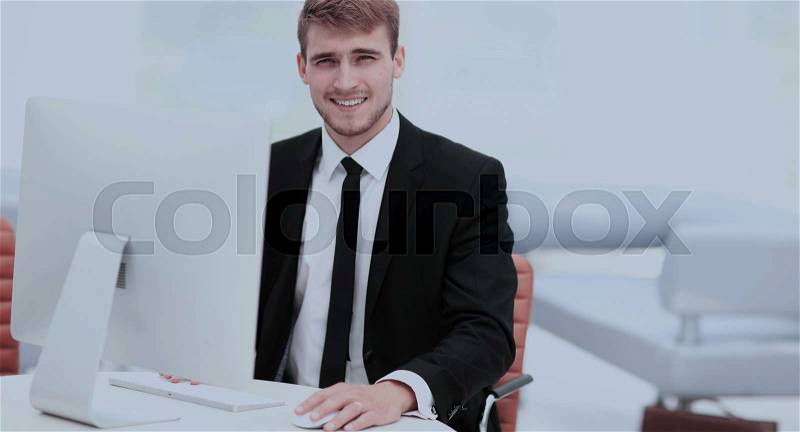 Portrait of happy businessman at the workplace, stock photo