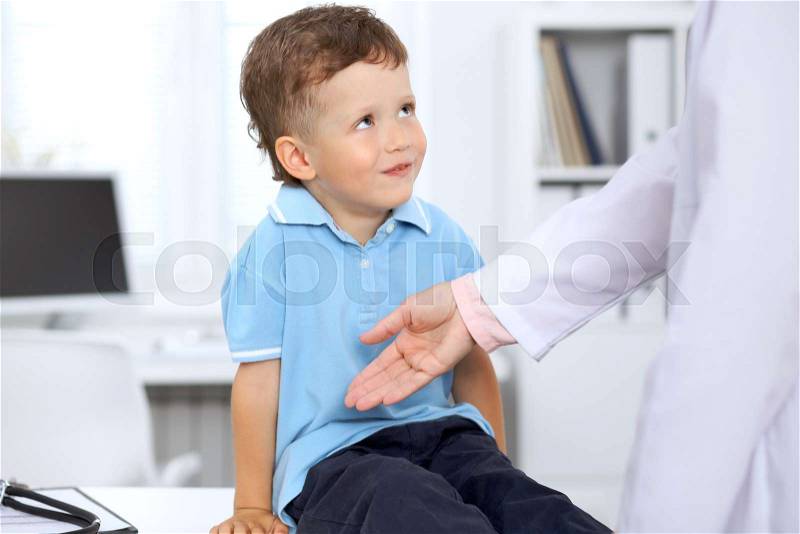 Happy little boy after health exam at doctor\'s office, stock photo