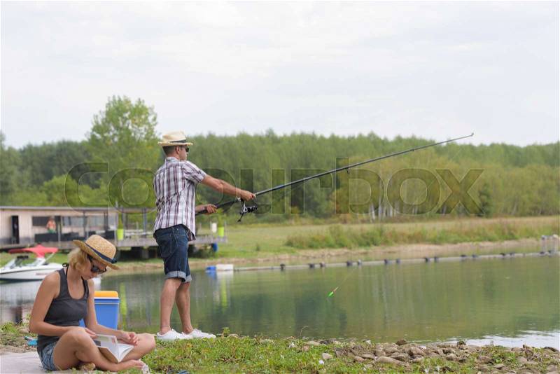 Couple fishing on a lake, stock photo