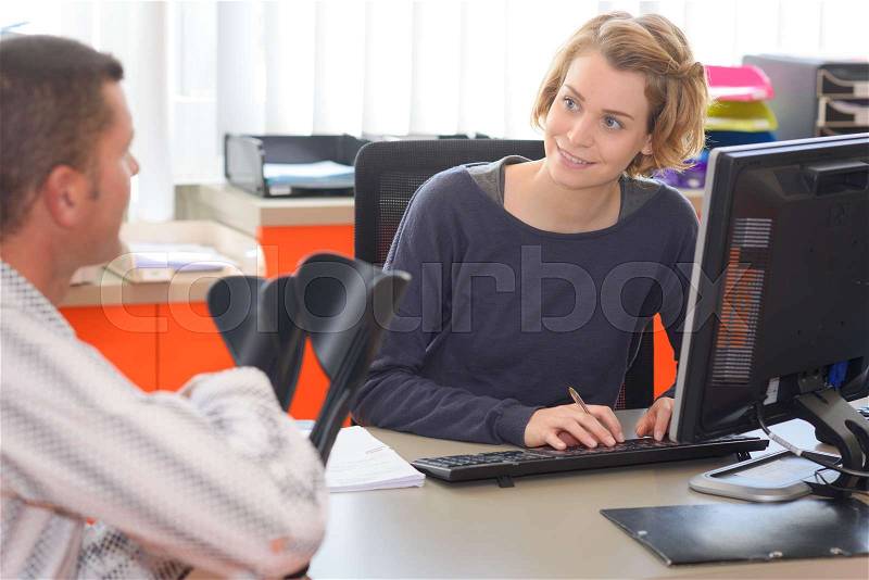 Female health insurance with male patient in office, stock photo