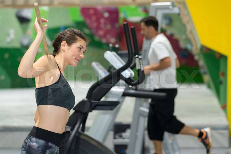 Sporty woman running on treadmills at the gym, stock photo