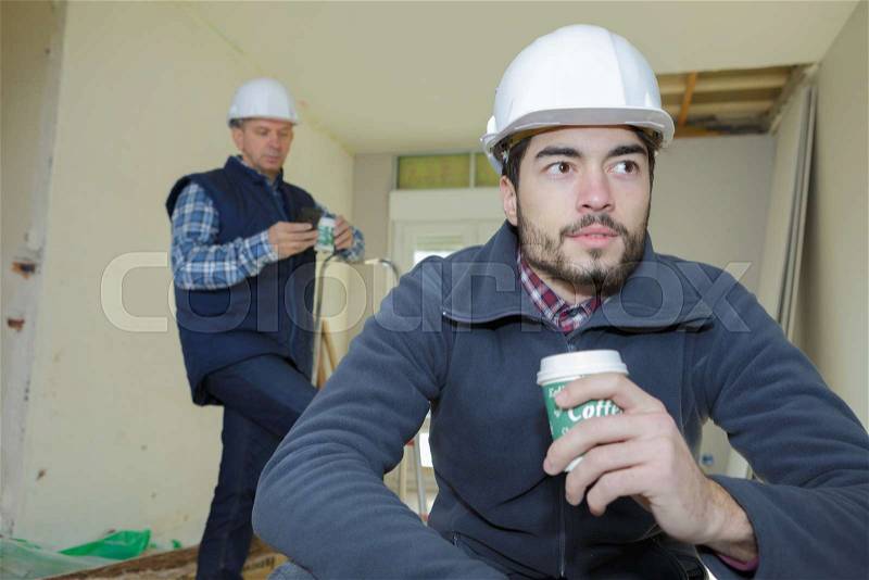 Worker on a break drinking coffee and having a rest, stock photo