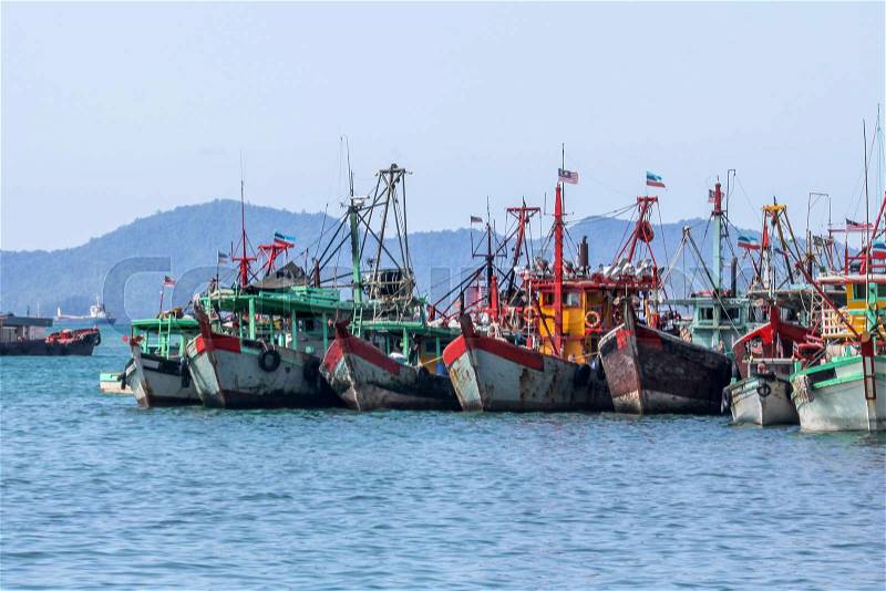 Row of Malaysian fishing boats at the bay close to Kota Kinabalu, Borneo, Malaysia, stock photo