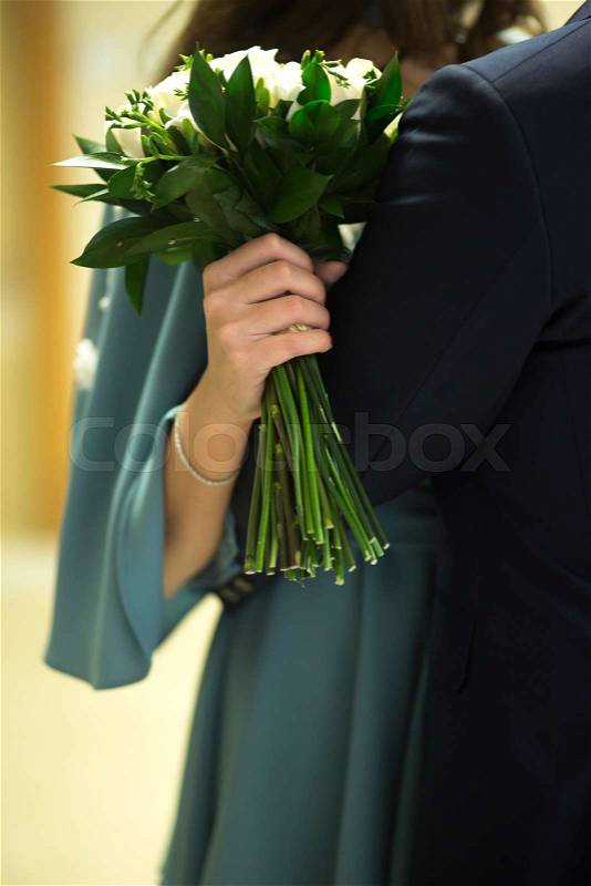 Civil non religious wedding ceremony registry office bridal bouquet of roses flowers of the bride with groom, stock photo
