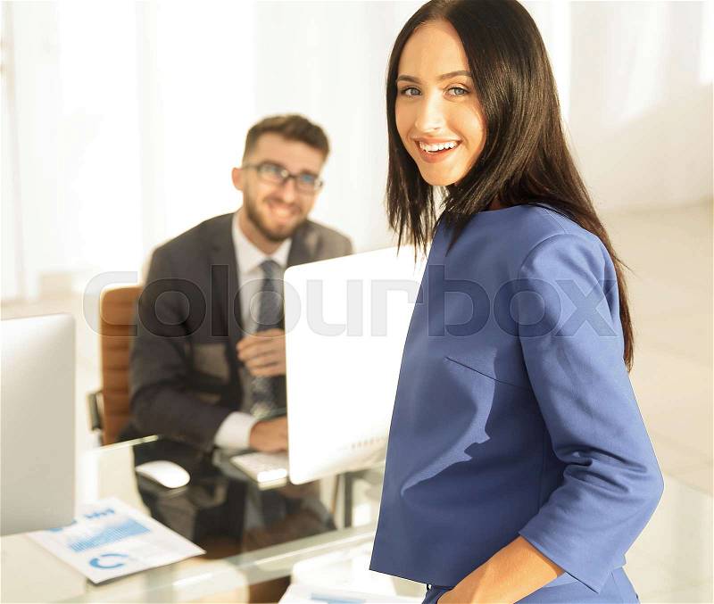 A confident manager discussing with a colleague a project, stock photo