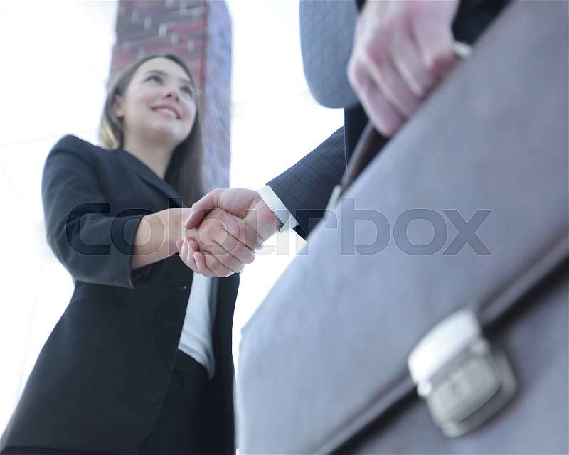 Successful business people handshaking after perfect deal, stock photo