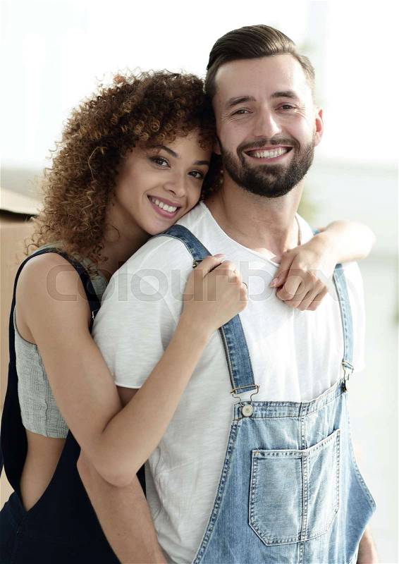 Newly-married couple in work clothes. Repair and moving to a new apartment, stock photo