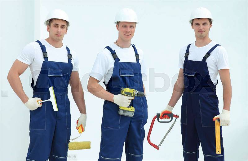 Team of construction workers with working tools, stock photo