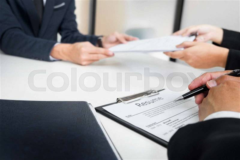 Hands of man giving application portfolio to HR man in office for interview, stock photo
