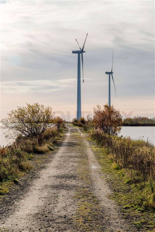 Wind Power Stations by Gravel Road and Ocean, stock photo