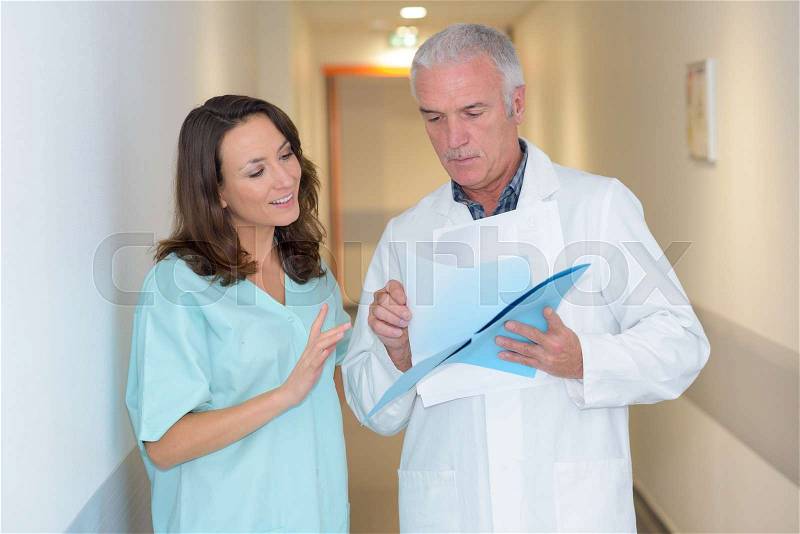 Intern and doctor on the hallway, stock photo