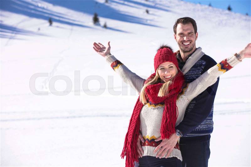 Happy couple playful together during winter holidays vacation outside in snow park, stock photo