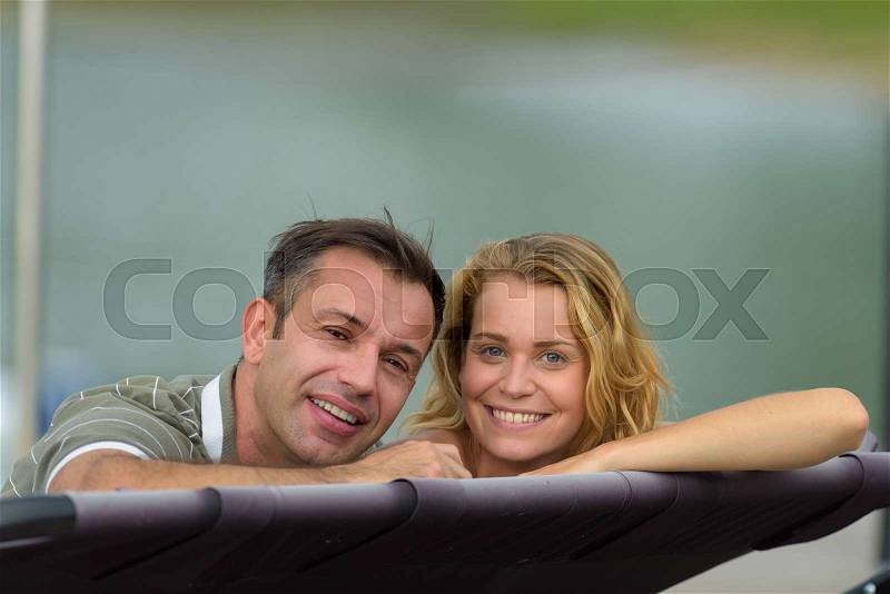 Happy couple at a lake in the countryside, stock photo