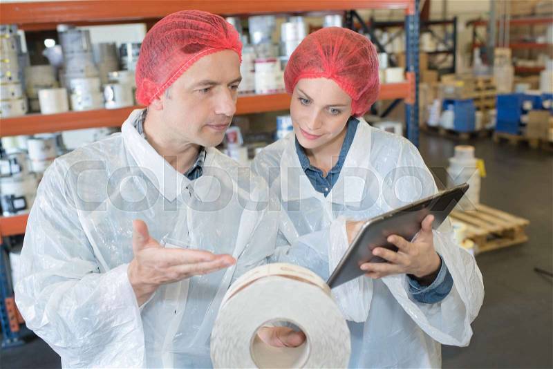 Workers in medical factory supplies storage, stock photo