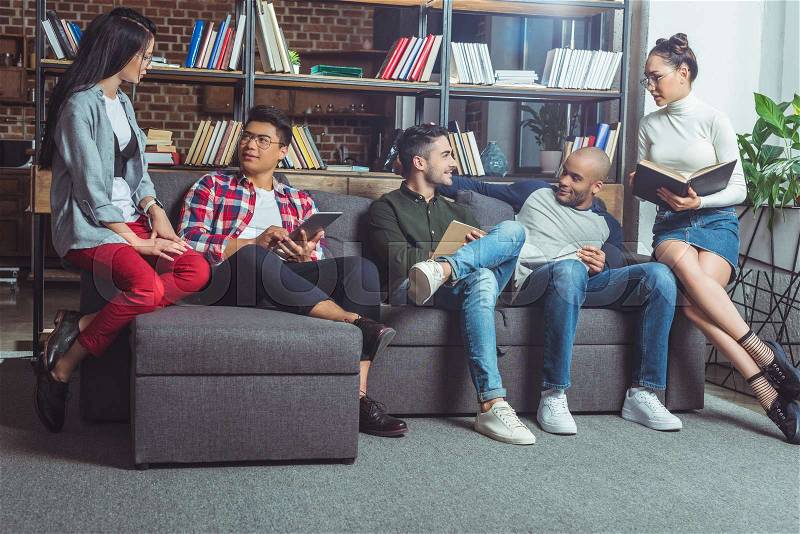 Group of young multiethnic friends studying together indoors, stock photo