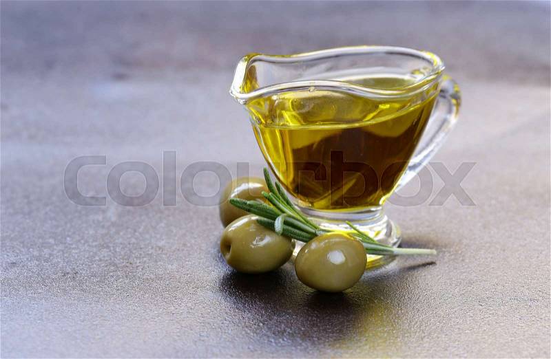Vegetable oil from olives in a glass sauce vessel, stock photo