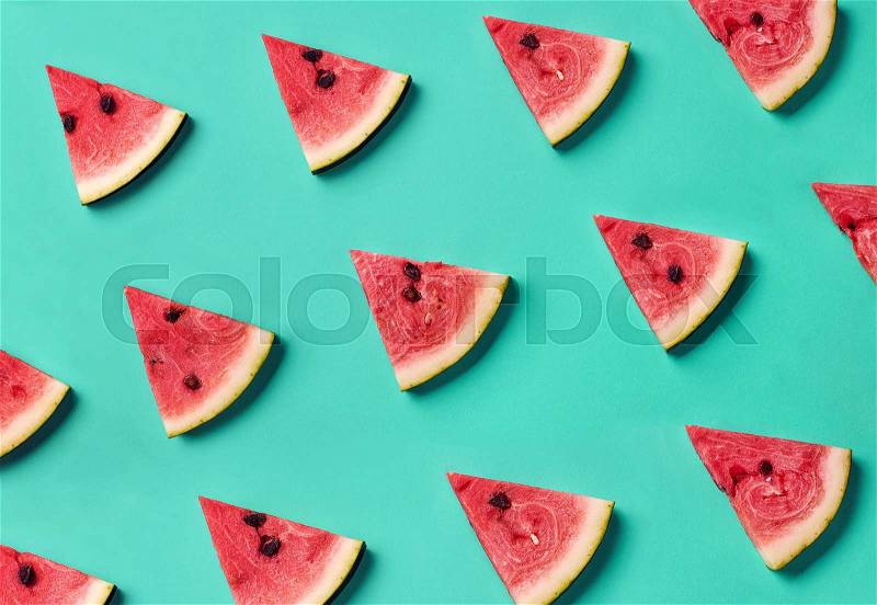 Colorful fruit pattern of fresh watermelon slices on blue background. From top view, stock photo