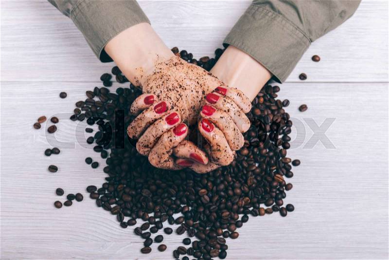 Female hands in coffee scrub close-up, top view, stock photo