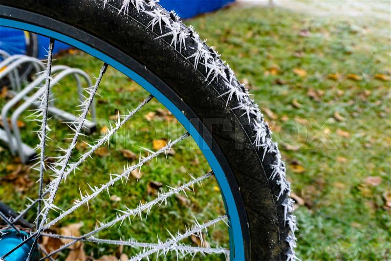 Detail from a bicycle tire with hoarfrost in winter, stock photo