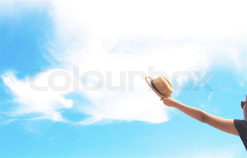 Woman hand holding straw hat, hands up, freedom and happy concept, stock photo