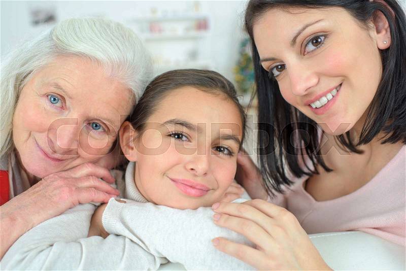 Three generations of the family resting on the couch, stock photo