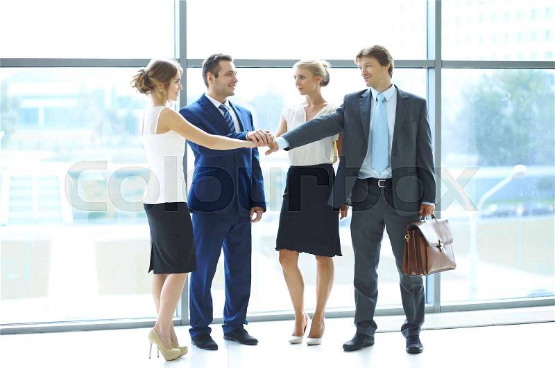 Business people group joining hands and representing concept of friendship and teamwork, stock photo