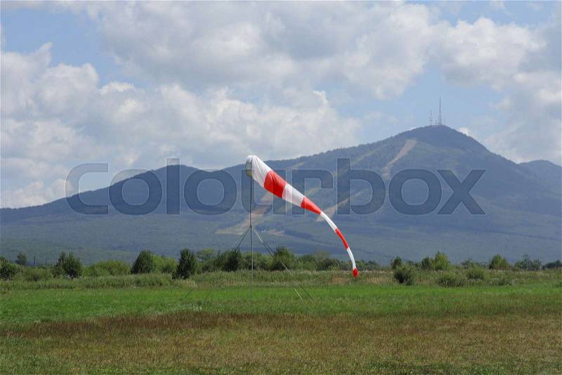 Pointer to the direction and strength of wind against the background of the sky, stock photo