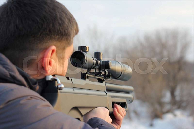 Hunter with rifle ready for shoot the target, stock photo