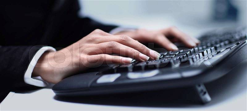 Female hands typing on computer keyboard, stock photo