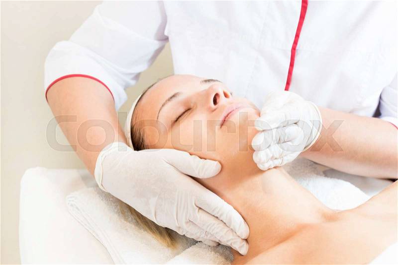 Massage and facial peels at the salon using cosmetics, stock photo